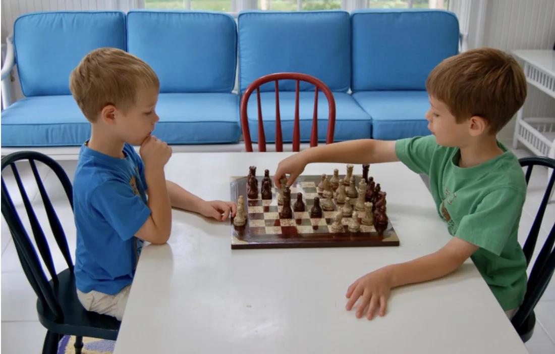 Ben and Alex Joel playing chess together as children